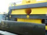 a large yellow machine that is sitting in the back of a truck