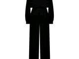 the silhouette of a woman in a black jumpsuit is shown