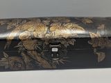 a black and gold box with flowers on it