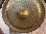 a large metal gong on a stand in a room