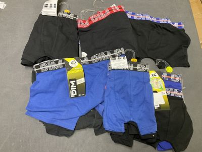 several pairs of men ' s underwear are laid out on the floor