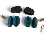 three pieces of jewelry that are sitting on a white surface