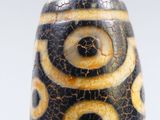a close up of a black and white glass bead
