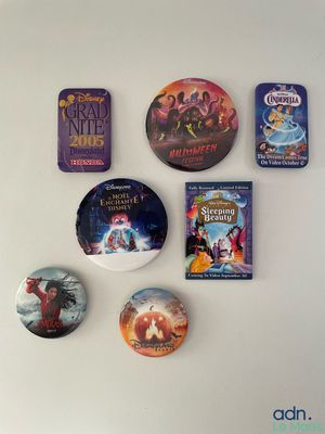 a lot of disney movie buttons on the wall