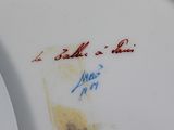 a close up of a plate with writing on it