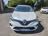 the front of a white car parked in a parking lot