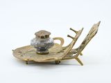 a silver and gold plate with a bird on it