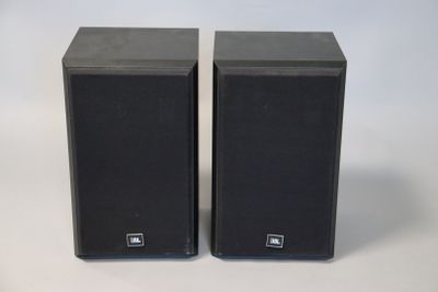 two black speakers sitting side by side on a white surface