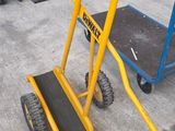 a small hand truck with a yellow handle and a blue hand truck