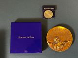 purple box with a gold medal and a blue box with a gold medal