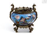 a blue vase with flowers on it on a stand