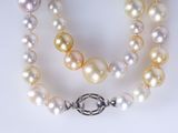 two strands of pearl necklaces with a clasp on a white background