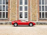 a red sports car parked in front of a brick building
