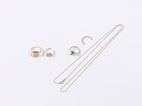 three pieces of jewelry are laying out on a white surface