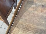 a small wooden table with a drawer on top of it