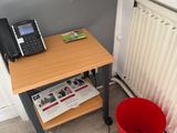 a red bucket and a red mop sitting on a table next to a phone