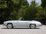 a silver car parked in a parking lot with trees in the background