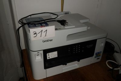 a printer sitting on top of a desk with a price tag on it