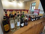many bottles of alcohol sitting on a counter in a room