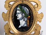 a gold frame with a picture of a man with a wreath on it