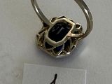 a ring with a black stone in it on a table