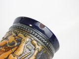 a blue vase with a picture of a lion on it