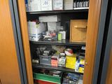 a cabinet with many items in it in a room