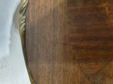 a close up of a wooden table with a clock on it