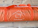 an orange bag with a house on it sitting on a wooden floor