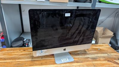 a computer monitor sitting on top of a wooden desk