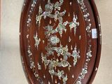 a picture of a wooden plate with flowers on it