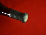 a close up of a bottle of wine on a red cloth