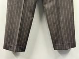 grey pinstripe pants hanging on a wall with a white wall in the background