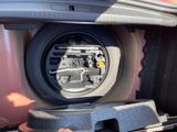 a close up of a car ' s front bumper with a speaker