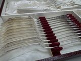 many forks in a box on a table