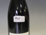 a bottle of wine that is sitting on a table