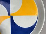 a white plate with a yellow and blue design on it
