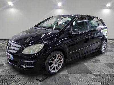 the black mercedes b - class is parked on a checkered floor