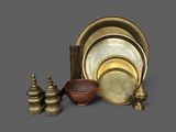 an image of a group of brass objects on a gray surface