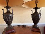 two lamps on a table with a lamp shade on top of it