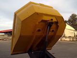 a large yellow dump truck sitting in the middle of a parking lot