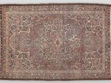 an antique persian rug with a floral design on a brown ground