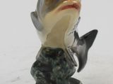 figurines of a fish and a fish on a white surface