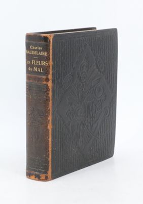 an old book sitting on top of a table next to a white background