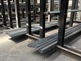 several steel racks are lined up in a warehouse area