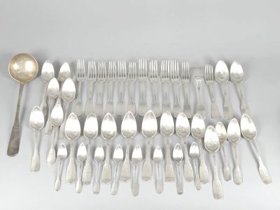 a lot of silver spoons and spoons laid out on a table