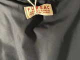 the back of a black jacket with a label on it