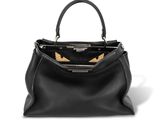 a black leather handbag with gold details on the handle