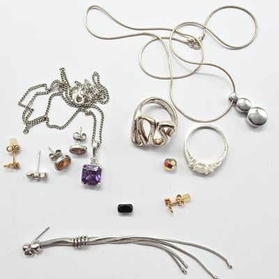 several different types of jewelry laid out on a white surface