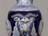 a blue and white vase sitting on a wooden table